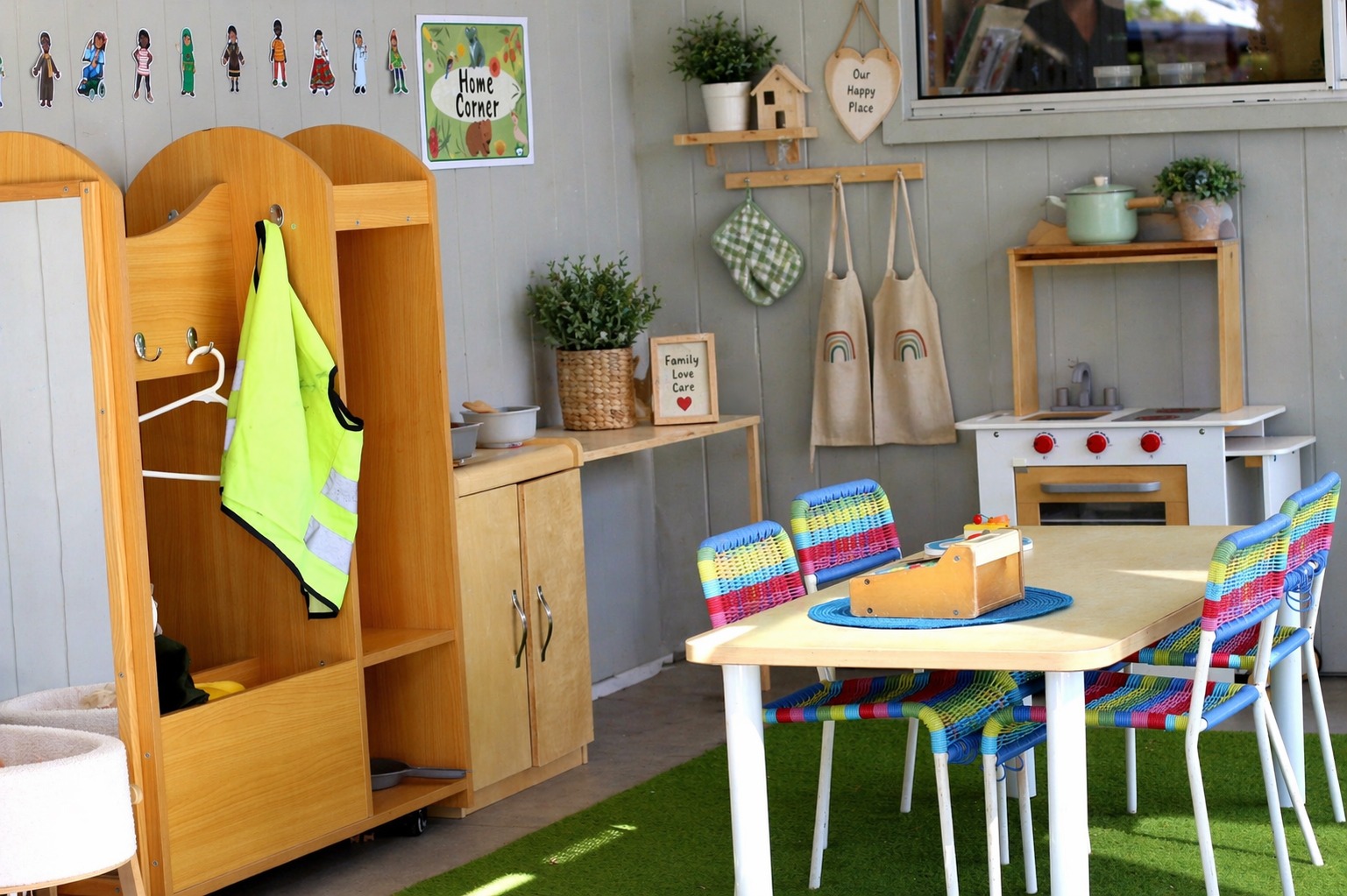 Home corner set up in outdoor undercover playground at Edge Peregian Beach childcare.