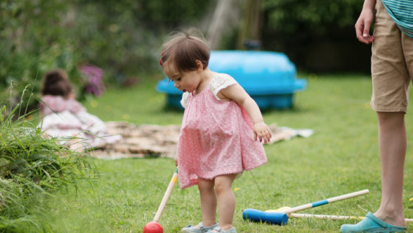 Girl playing croquet