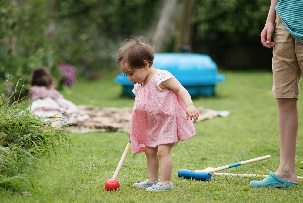 Girl playing croquet