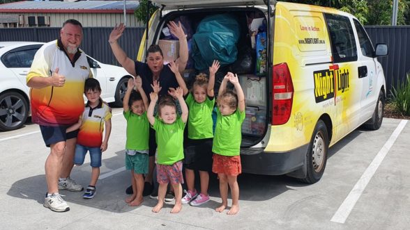 Children and Centre Director with flood donations in van
