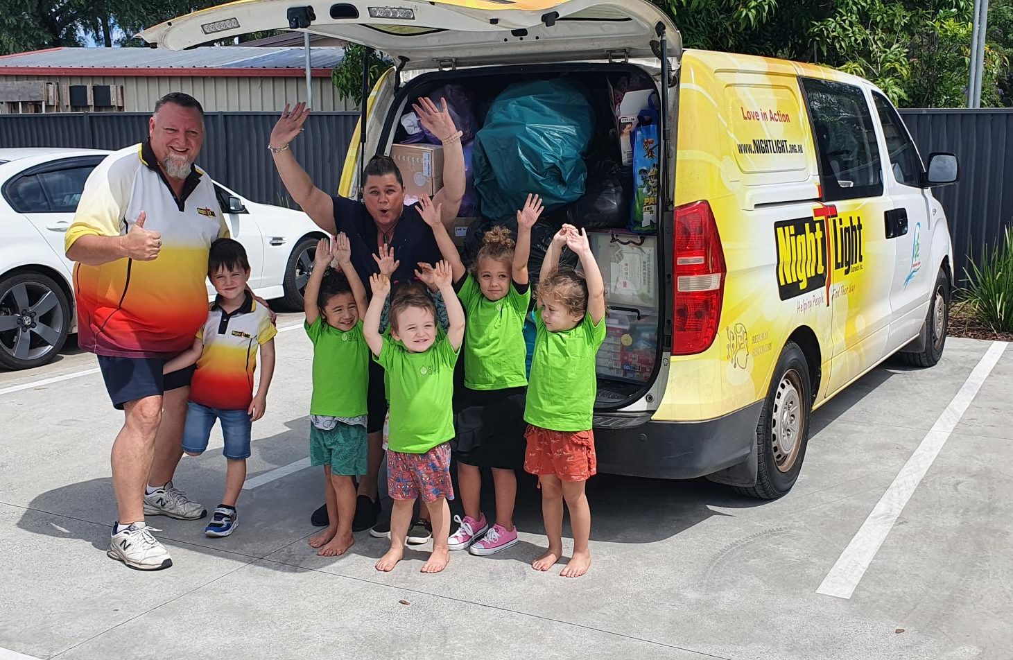 Children and Centre Director with flood donations in van