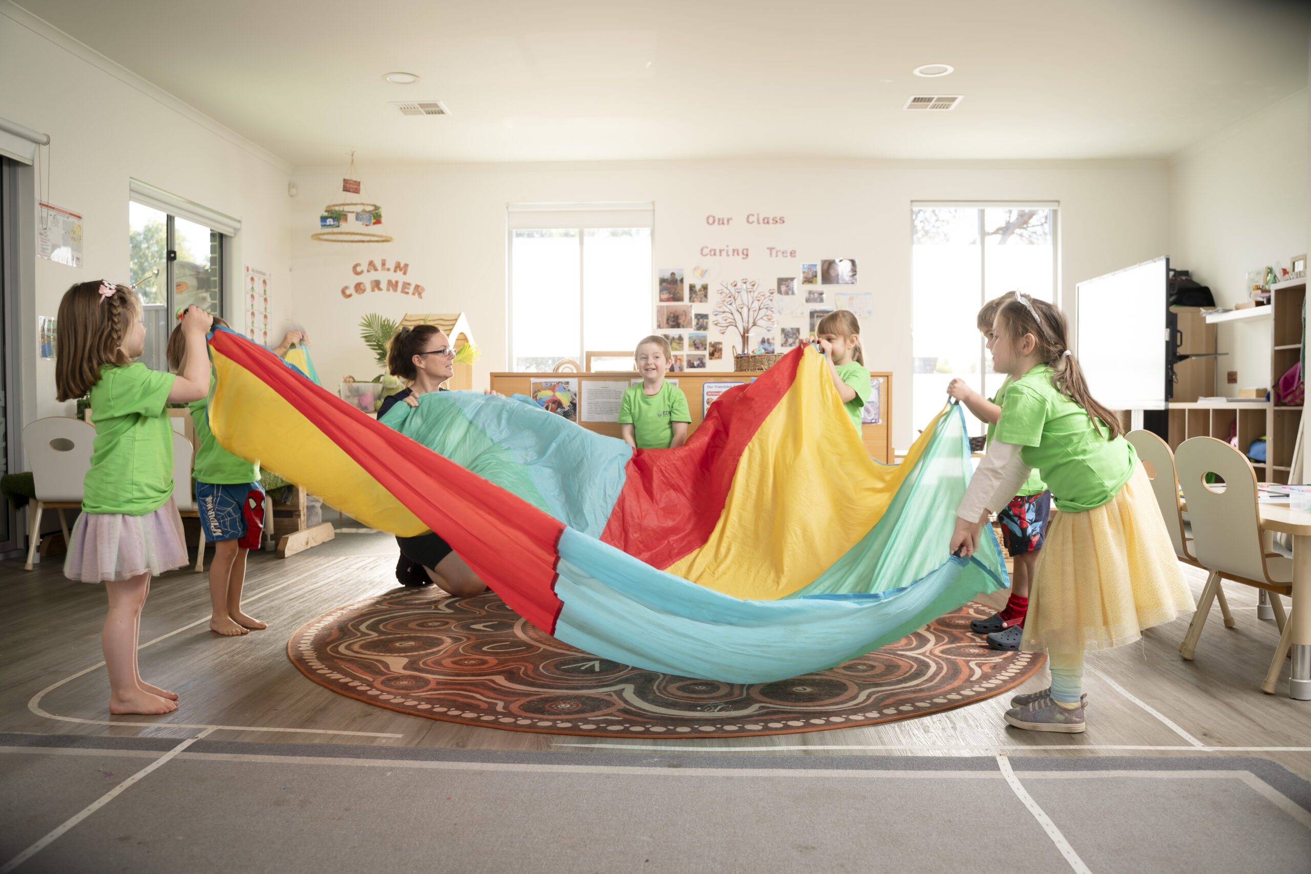 Children and teacher enjoying parachute play at Strathalbyn day care.