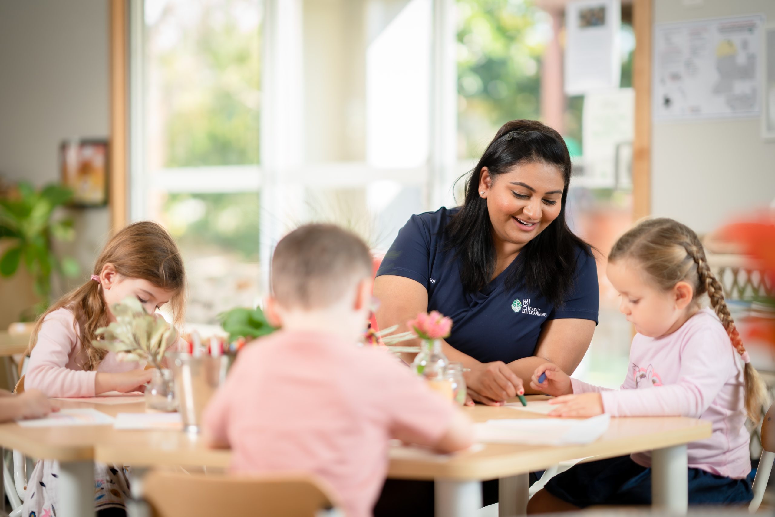 Educator teaching literacy to preschool children at a Hallett Cove preschool