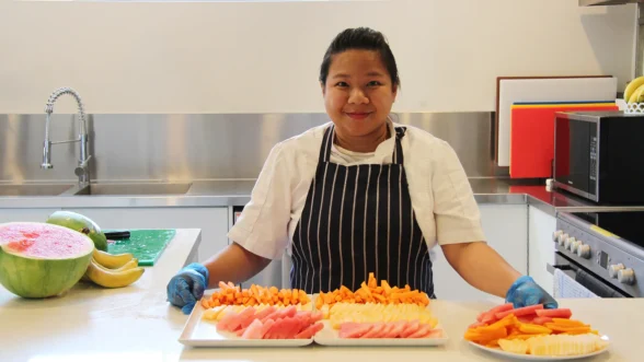 Chef with fruit platters in the kitchen at Edge childcare in Ferny Grove.